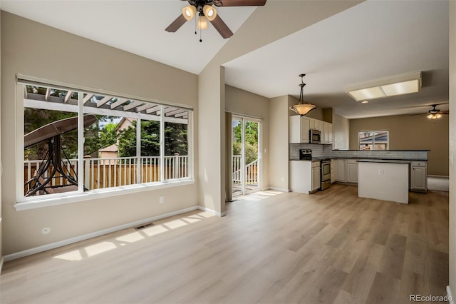 9417 Burgundy Cir, Highlands Ranch, CO 80126 - unfurnished living room with a ceiling fan, light wood-type flooring, and high vaulted ceiling