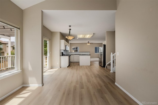 9417 Burgundy Cir, Highlands Ranch, CO 80126 - unfurnished living room featuring light wood-type flooring and ceiling fan