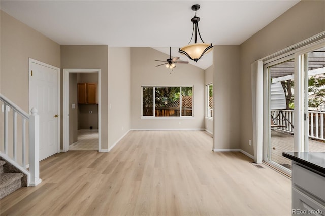 9417 Burgundy Cir, Highlands Ranch, CO 80126 - unfurnished dining area with light wood finished floors, a ceiling fan, stairs, and lofted ceiling