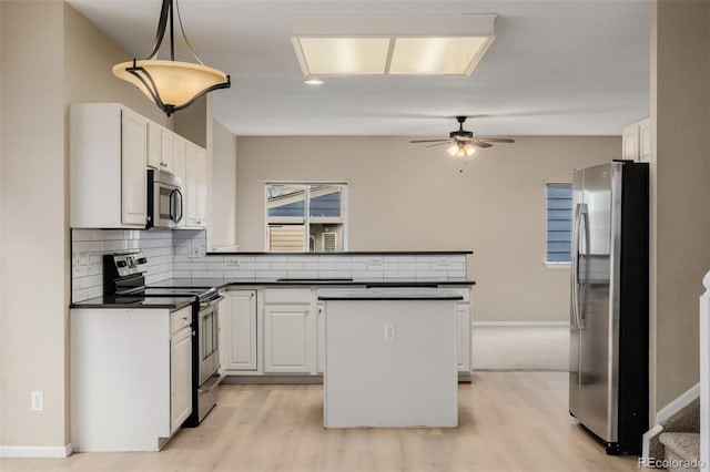 9417 Burgundy Cir, Highlands Ranch, CO 80126 - kitchen with dark countertops, stainless steel appliances, light wood-style floors, and a peninsula