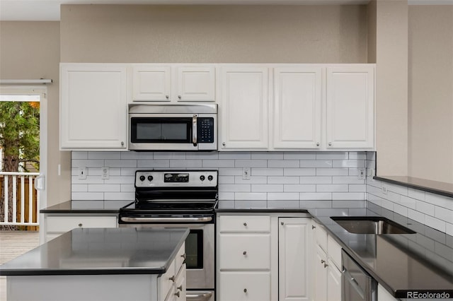 9417 Burgundy Cir, Highlands Ranch, CO 80126 - kitchen with stainless steel appliances, dark countertops, and white cabinetry