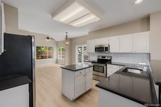 9417 Burgundy Cir, Highlands Ranch, CO 80126 - kitchen with dark countertops, stainless steel appliances, backsplash, and a ceiling fan