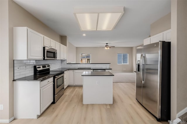 9417 Burgundy Cir, Highlands Ranch, CO 80126 - kitchen with stainless steel appliances, dark countertops, a peninsula, light wood-style floors, and recessed lighting
