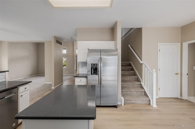 9417 Burgundy Cir, Highlands Ranch, CO 80126 - kitchen with dark countertops, appliances with stainless steel finishes, and white cabinets