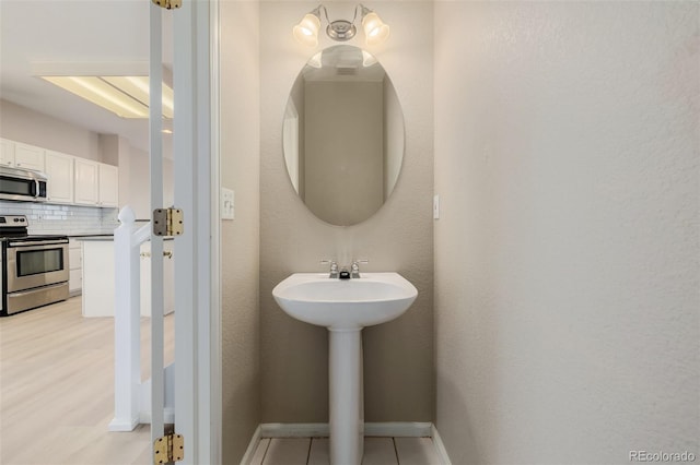 9417 Burgundy Cir, Highlands Ranch, CO 80126 - bathroom with tasteful backsplash and baseboards