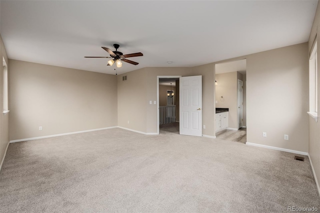 9417 Burgundy Cir, Highlands Ranch, CO 80126 - unfurnished bedroom featuring light carpet, ensuite bath, and a ceiling fan