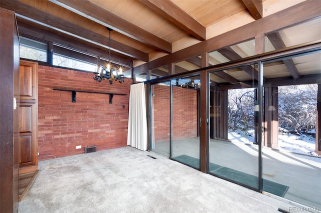 interior space with a notable chandelier and beam ceiling