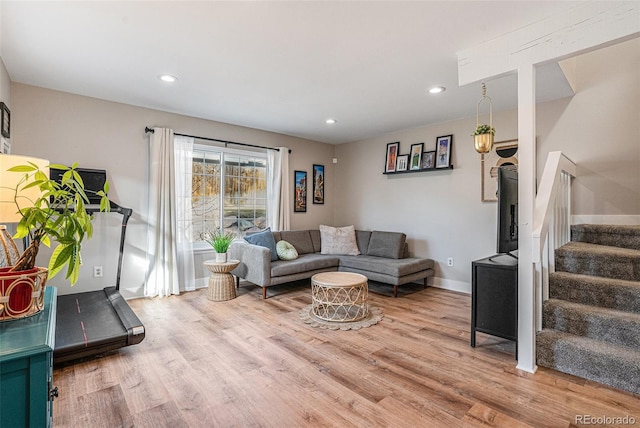 living area featuring stairs, recessed lighting, light wood-style floors, and baseboards