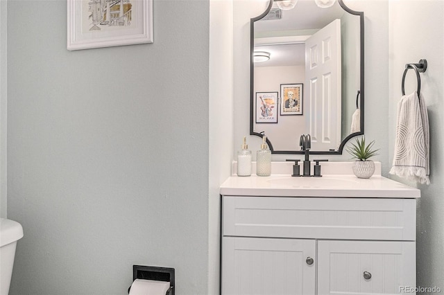 half bathroom featuring toilet and vanity