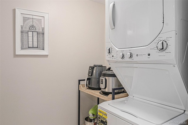 laundry room with stacked washer and clothes dryer and laundry area