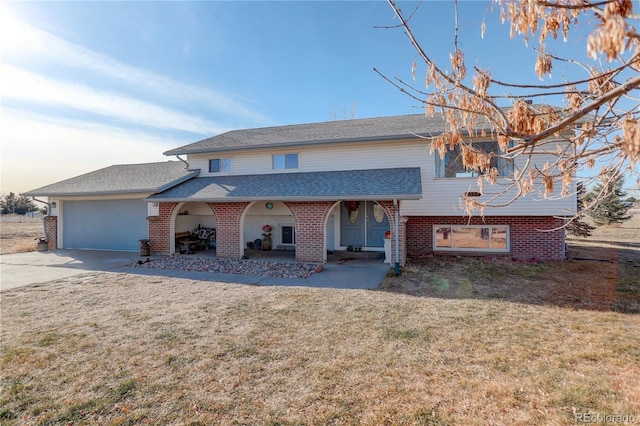 view of front of house with a front lawn and a garage