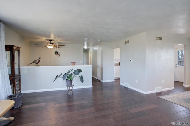 interior space featuring ceiling fan and dark wood-type flooring