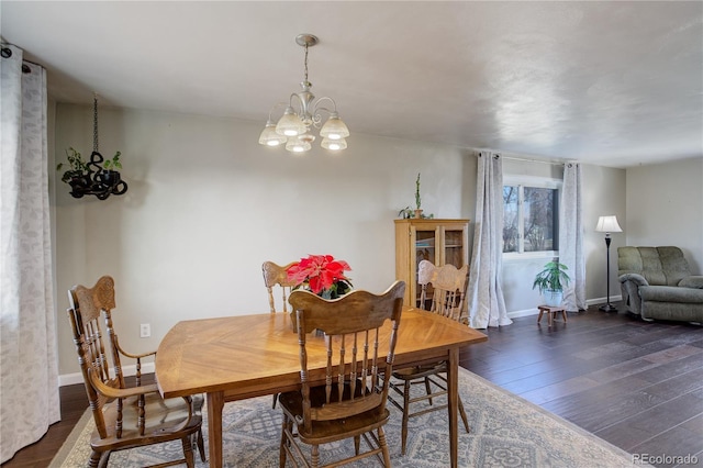 dining room featuring dark hardwood / wood-style floors and an inviting chandelier