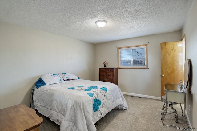 bedroom featuring a textured ceiling and light carpet