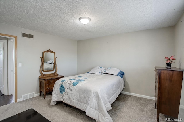 carpeted bedroom with a textured ceiling