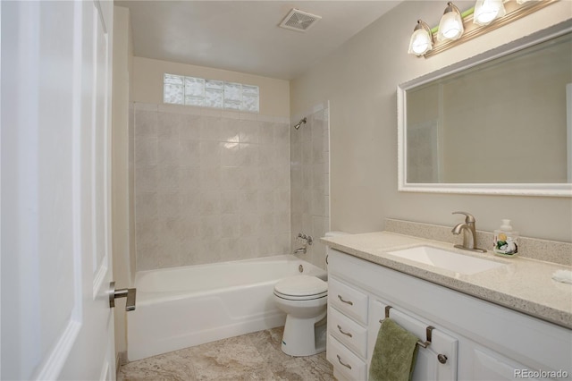 full bathroom featuring toilet, vanity, and tiled shower / bath