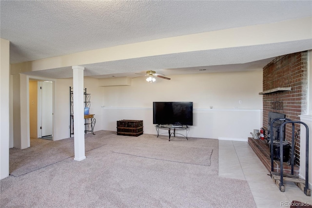 tiled living room with ceiling fan and a textured ceiling