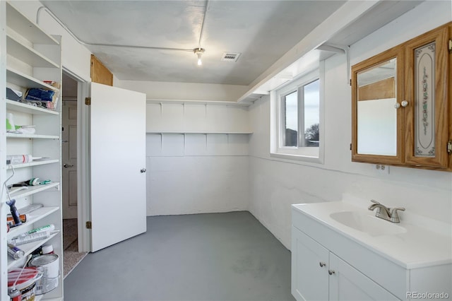 bathroom with vanity and concrete floors