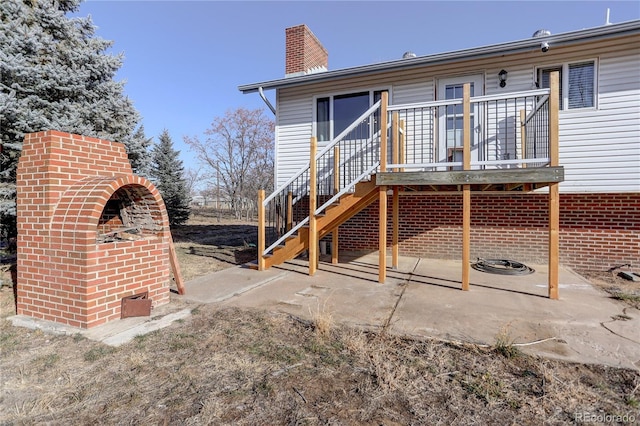 rear view of house with a patio and a wooden deck