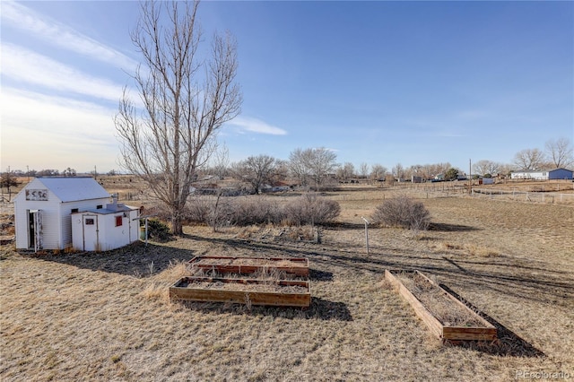 view of yard with a rural view and a shed