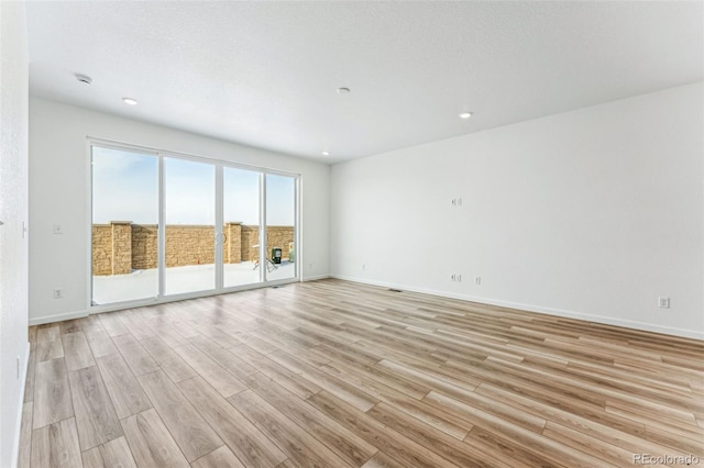 unfurnished room featuring light hardwood / wood-style flooring