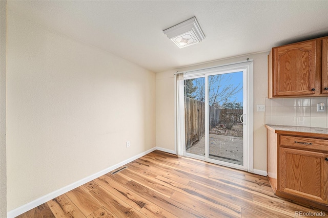 unfurnished dining area with light hardwood / wood-style floors