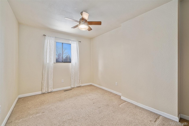 carpeted empty room featuring a textured ceiling and ceiling fan