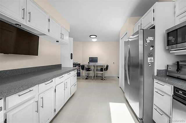 6223 W Flora Pl, Denver, CO 80227 - kitchen featuring stainless steel appliances, white cabinetry, and an office area
