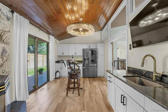 6223 W Flora Pl, Denver, CO 80227 - kitchen with stainless steel fridge with ice dispenser, a sink, wood ceiling, separate washer and dryer, and white cabinets