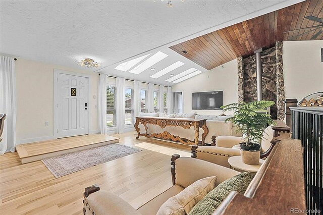 6223 W Flora Pl, Denver, CO 80227 - living area featuring vaulted ceiling, wood finished floors, and a skylight