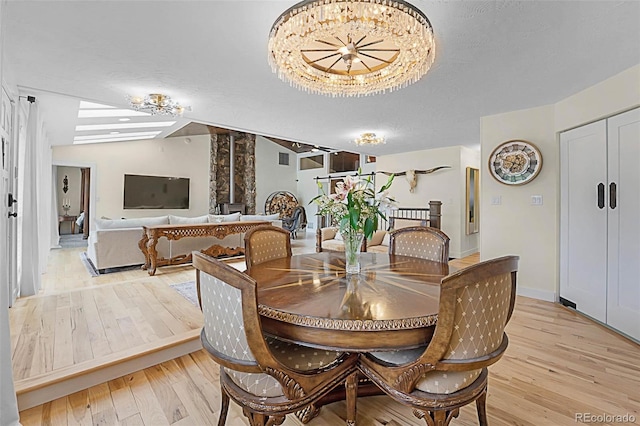 6223 W Flora Pl, Denver, CO 80227 - dining room featuring light wood-type flooring and a chandelier