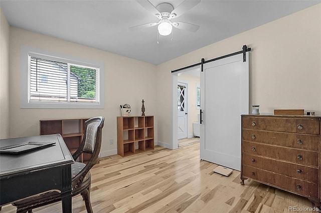 6223 W Flora Pl, Denver, CO 80227 - office space featuring ceiling fan, light wood-style flooring, a barn door, and baseboards