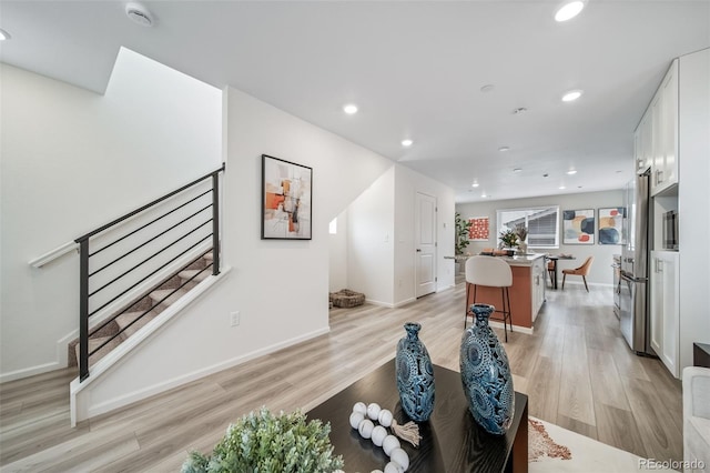 13029 E 103rd Pl, Commerce City, CO 80022 - living area with light wood-type flooring, recessed lighting, baseboards, and stairs