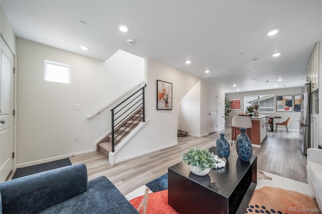 13029 E 103rd Pl, Commerce City, CO 80022 - living area with stairs, recessed lighting, light wood finished floors, and baseboards