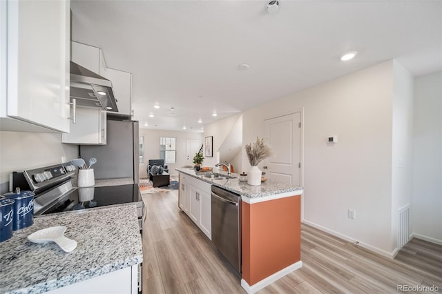 13029 E 103rd Pl, Commerce City, CO 80022 - kitchen featuring stainless steel appliances, white cabinets, light wood-type flooring, an island with sink, and a sink
