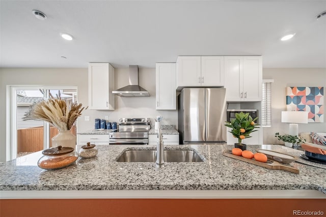 13029 E 103rd Pl, Commerce City, CO 80022 - kitchen with stainless steel appliances, wall chimney exhaust hood, a sink, white cabinetry, and light stone counters