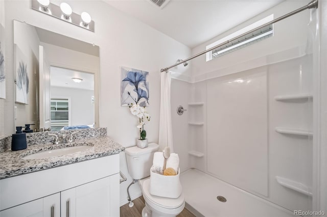 13029 E 103rd Pl, Commerce City, CO 80022 - full bath with curtained shower, vanity, healthy amount of natural light, and wood finished floors