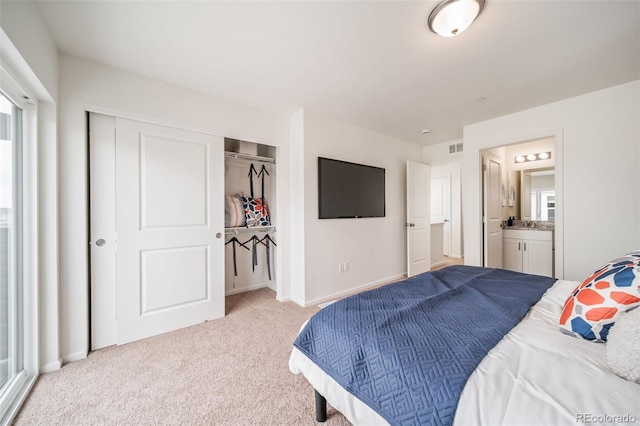 13029 E 103rd Pl, Commerce City, CO 80022 - bedroom with light colored carpet, a closet, ensuite bath, and baseboards