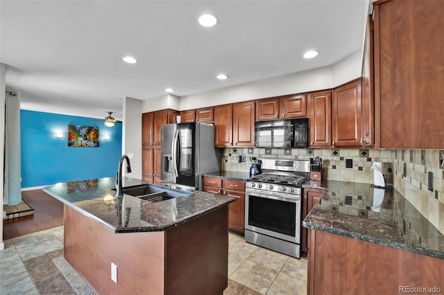 1065 Harbourne St, Colorado Springs, CO 80911 - kitchen with stainless steel appliances, a sink, decorative backsplash, dark stone counters, and recessed lighting