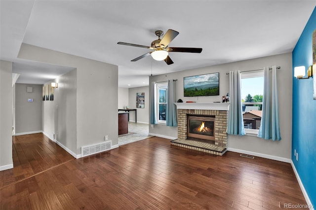 1065 Harbourne St, Colorado Springs, CO 80911 - unfurnished living room with ceiling fan, baseboards, a brick fireplace, and plenty of natural light