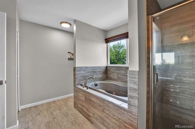 1065 Harbourne St, Colorado Springs, CO 80911 - full bathroom with a jetted tub, a stall shower, and baseboards