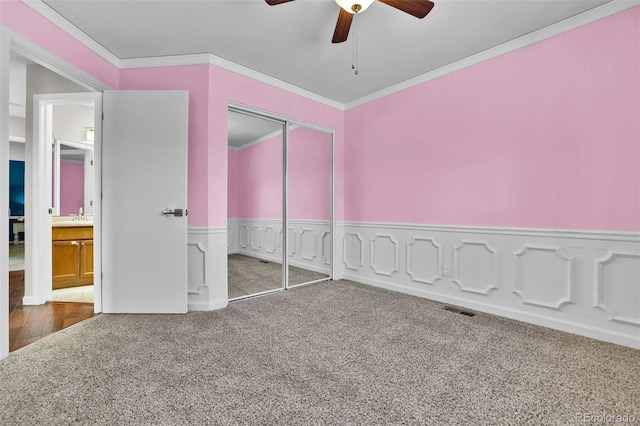1065 Harbourne St, Colorado Springs, CO 80911 - unfurnished bedroom with carpet flooring, ornamental molding, a closet, a sink, and wainscoting