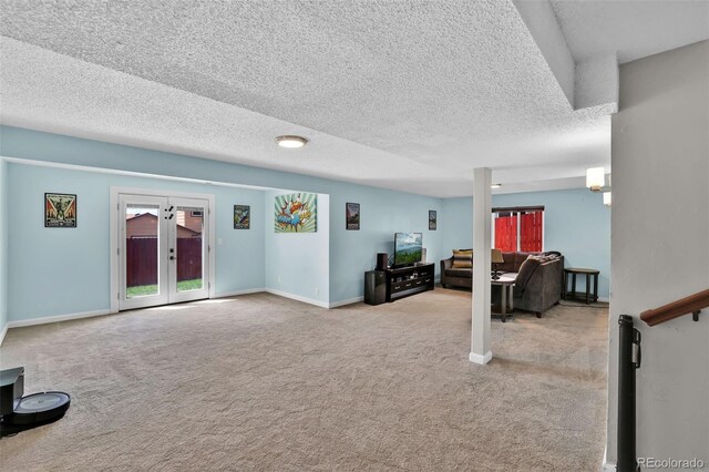 1065 Harbourne St, Colorado Springs, CO 80911 - carpeted living area featuring a textured ceiling, french doors, and baseboards