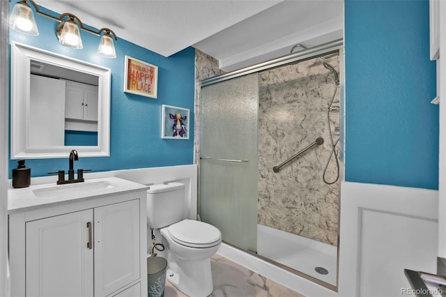 1065 Harbourne St, Colorado Springs, CO 80911 - full bath featuring toilet, a shower stall, vanity, a textured ceiling, and marble finish flooring