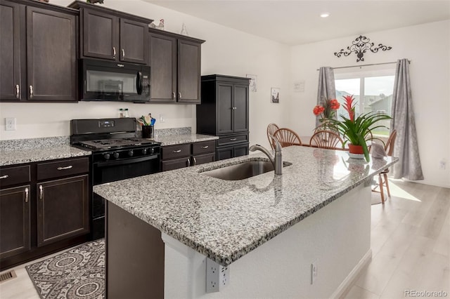 318 Thomas Ave, Keenesburg, CO 80643 - kitchen featuring black appliances, a sink, light wood finished floors, light stone counters, and recessed lighting