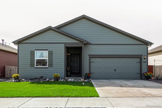 318 Thomas Ave, Keenesburg, CO 80643 - view of front of property with driveway and a garage