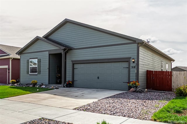 318 Thomas Ave, Keenesburg, CO 80643 - ranch-style home with fence, driveway, and a garage