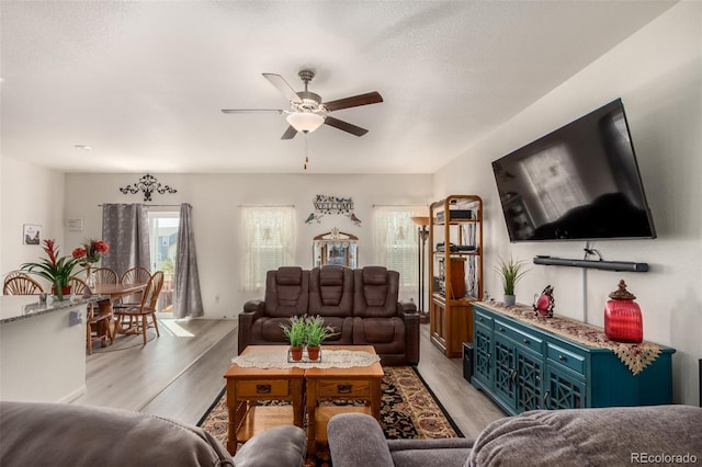 318 Thomas Ave, Keenesburg, CO 80643 - living area with ceiling fan and light wood-style floors