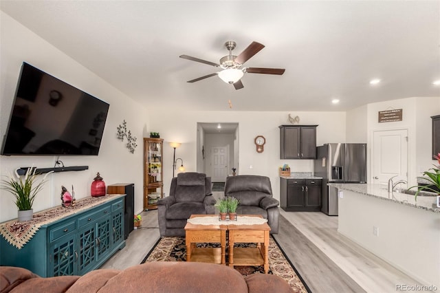 318 Thomas Ave, Keenesburg, CO 80643 - living room with light wood-style floors, ceiling fan, and recessed lighting