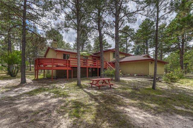 rear view of property with a wooden deck